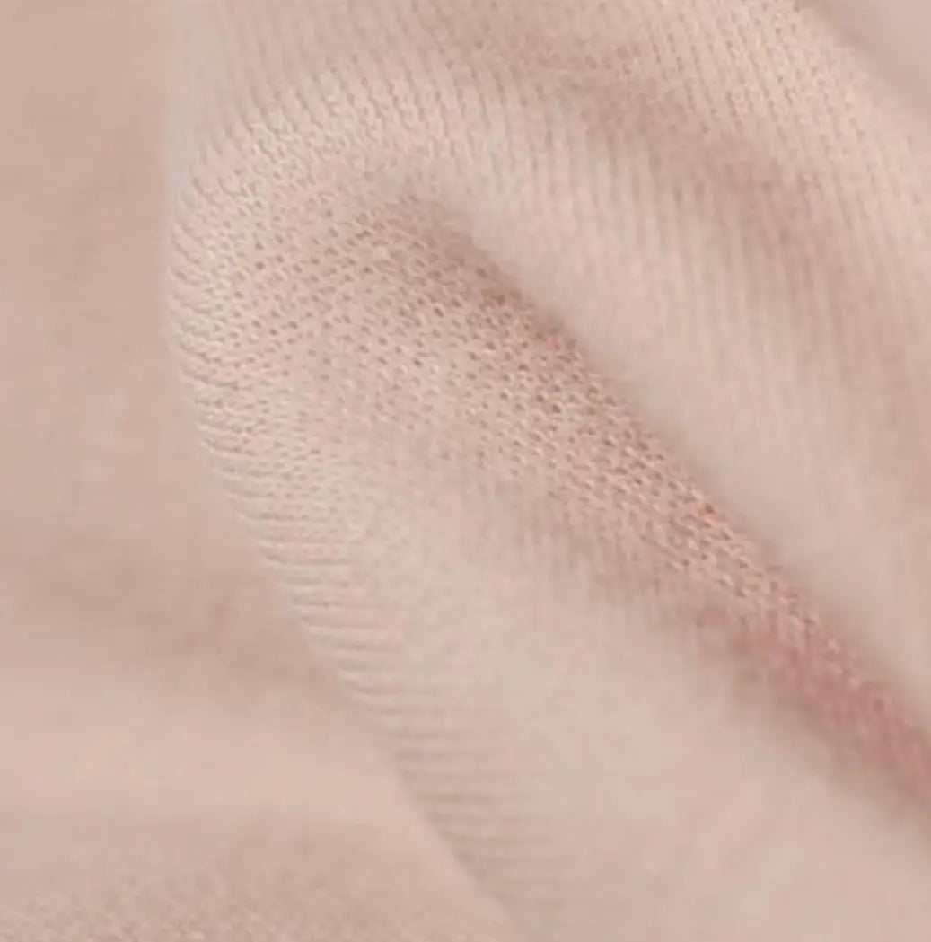 Close-up of textured cream organic cotton tricot dollmaking fabric