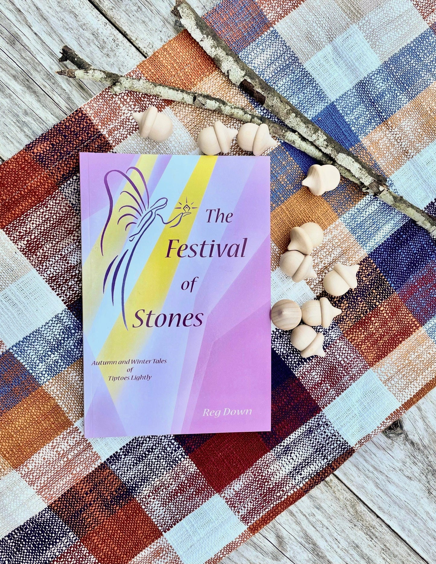 The Festival of Stones: Autumn and Winter Tales Book on an Autumn Tabletop with acorns