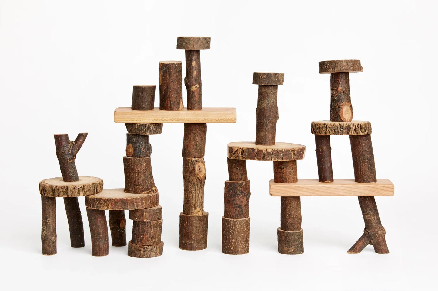 Barked Tree Blocks for open ended play stacked against a white background