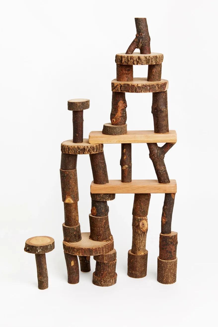 Barked Tree Blocks for open ended play stacked against a white background