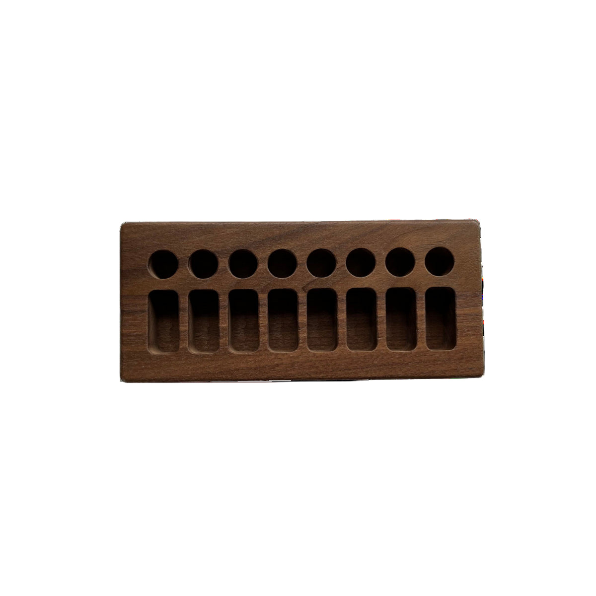 Wooden block with multiple holes on a white background