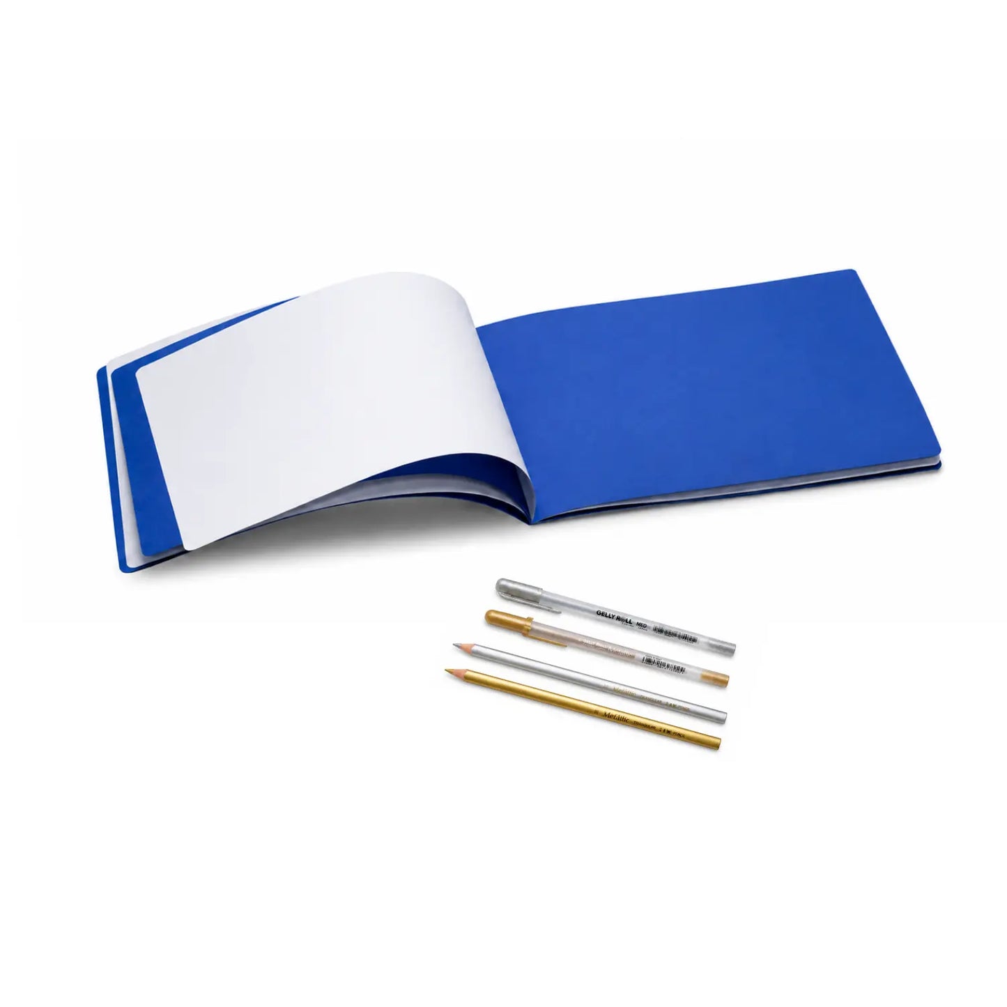 Landscape astronomy main lesson book open to alternating white and dark blue pages with metallic pens and pencils