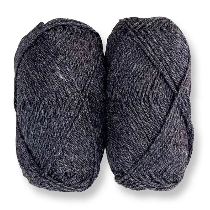 Two skeins of dark gray merino-silk yarn on a white background