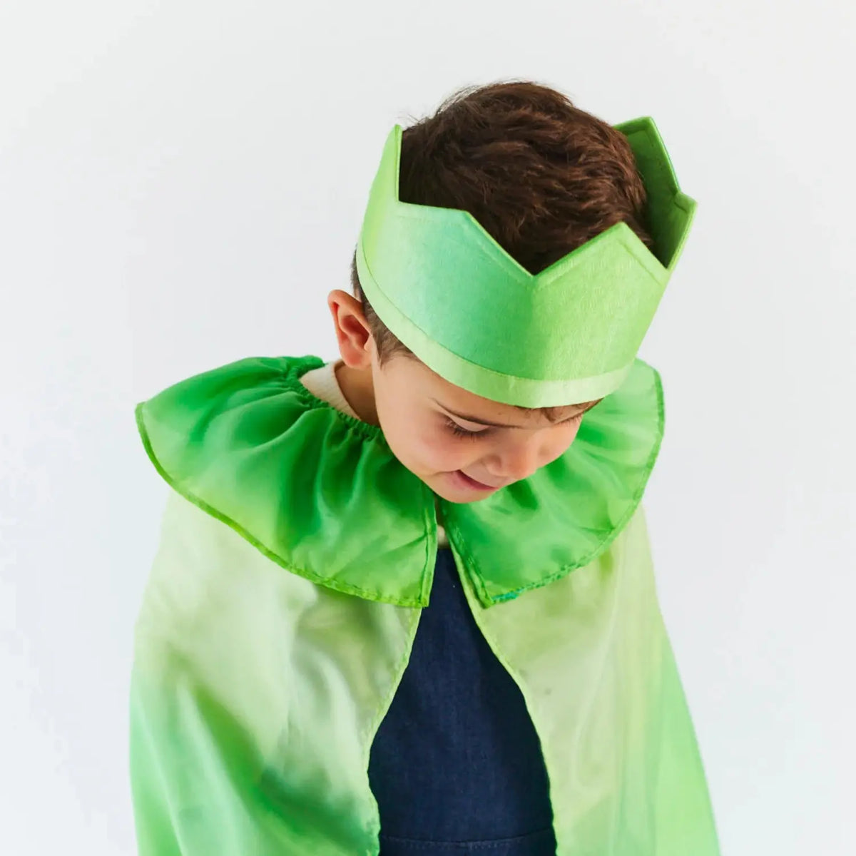 Child wearing the green Willow in the Wind silk crown with a matching green silk cape for woodland pretend play