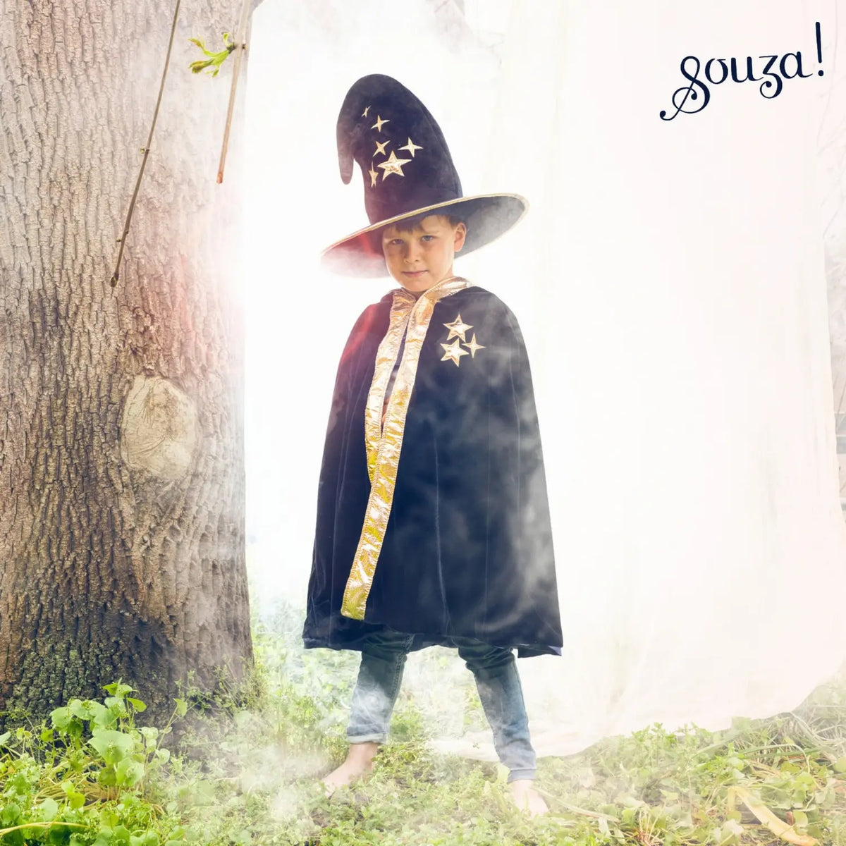 Child wearing blue magician cape with hood for imaginative outdoor dress-up play