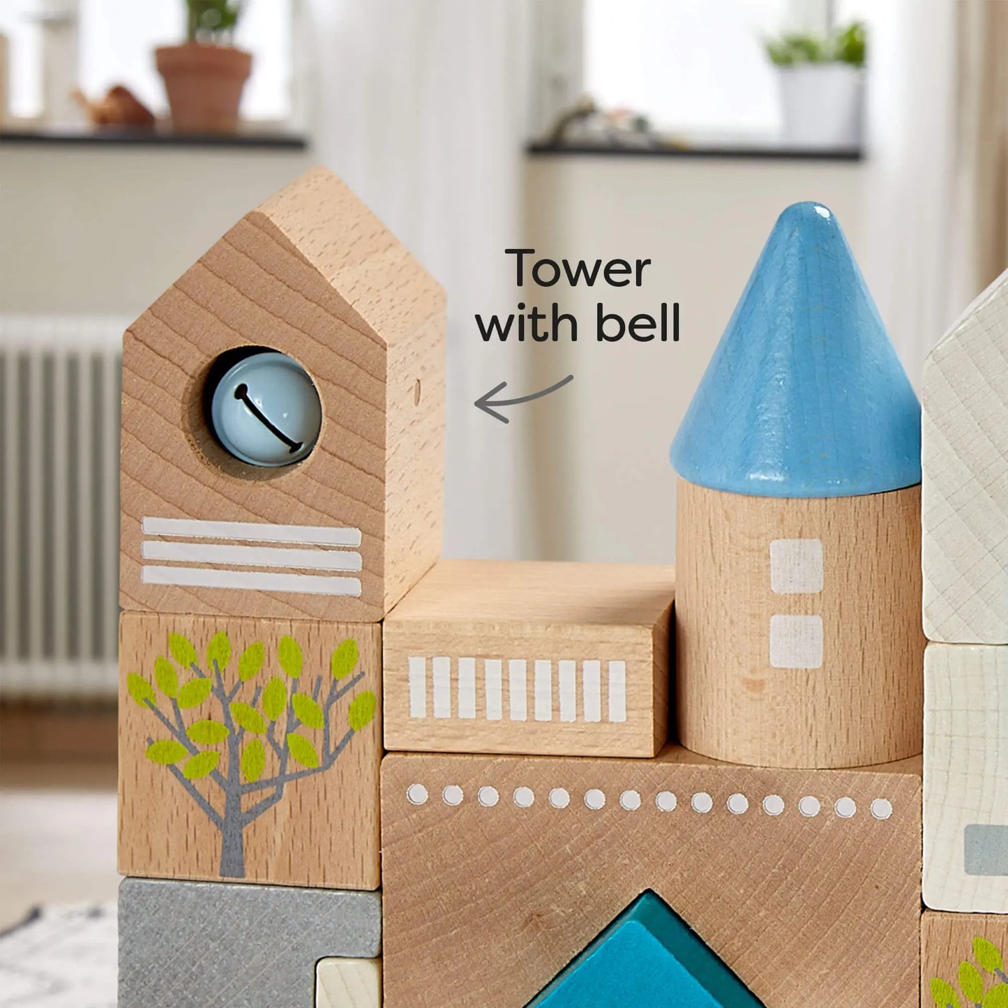 Close-up of HABA Bad Rodach wooden building blocks showing turret, bell tower, steeple in blue, silver, white, and natural wood