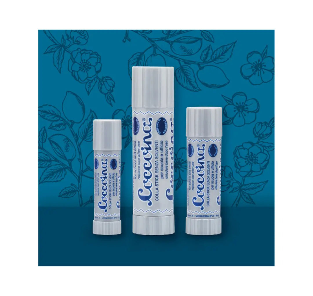 Three Coccoina glue sticks side by side on a teal background with hand drawn flowers and leaves