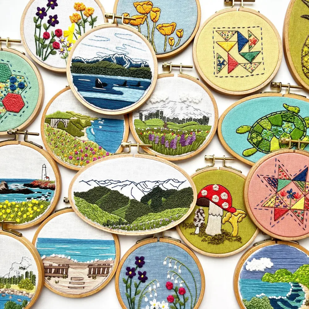 Collection of colorful hand embroidery hoop art projects featuring landscapes, flowers, geometric designs, and nature scenes