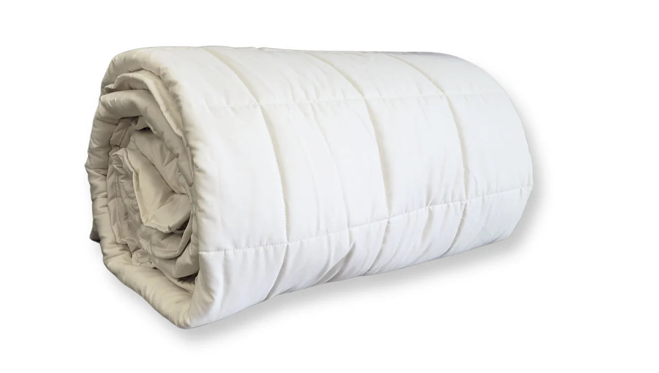 Side view of rolled quilted cotton comforter showing even fill distribution