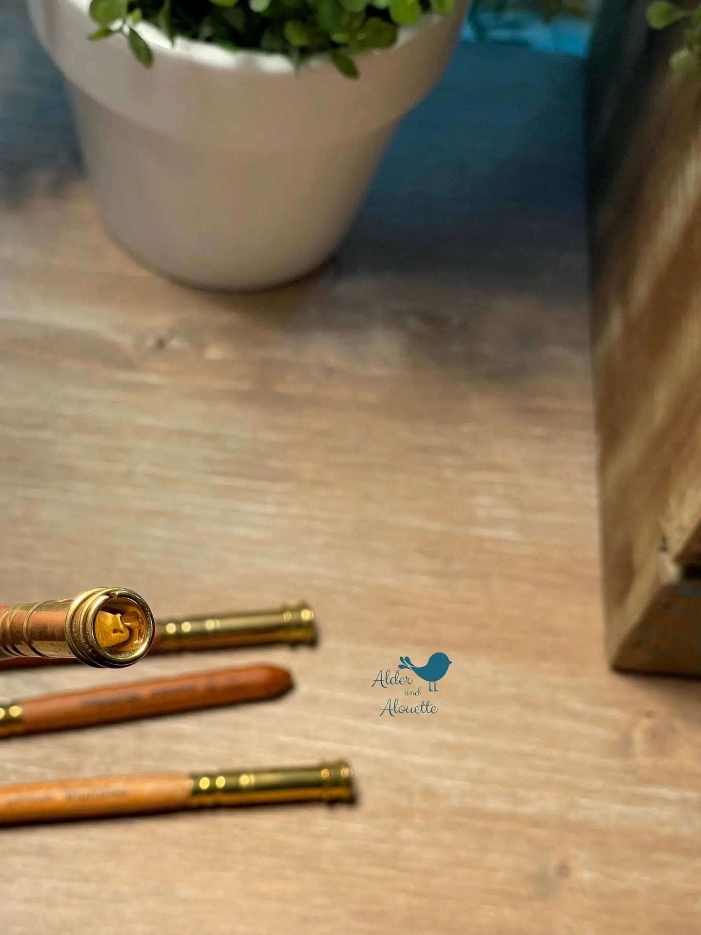 angled view of wooden pencil extender with brass holder highlighting craftsmanship and natural materials