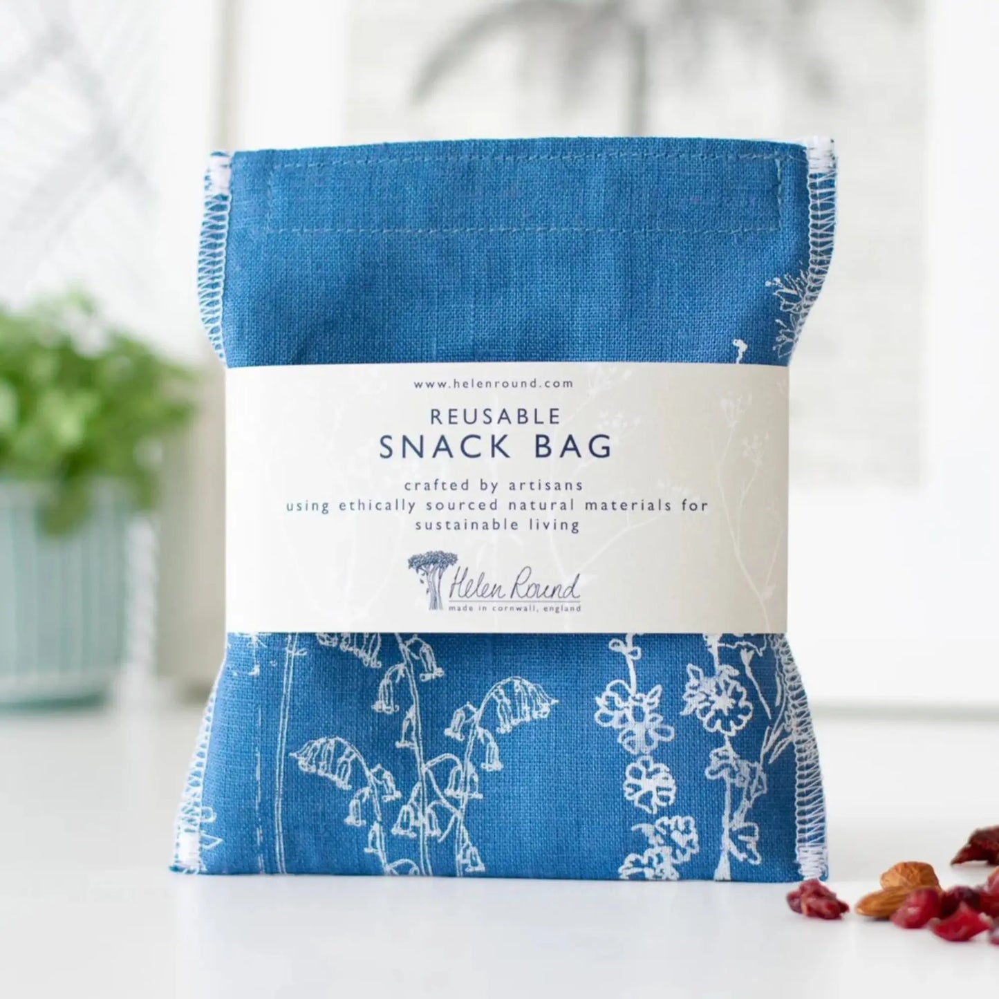 Reusable snack bag with floral design and visible branding on a white background