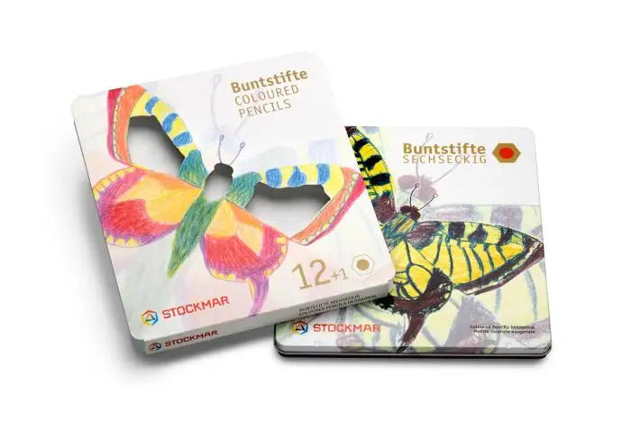 Two Stockmar colored pencil boxes with butterfly designs on a white background
