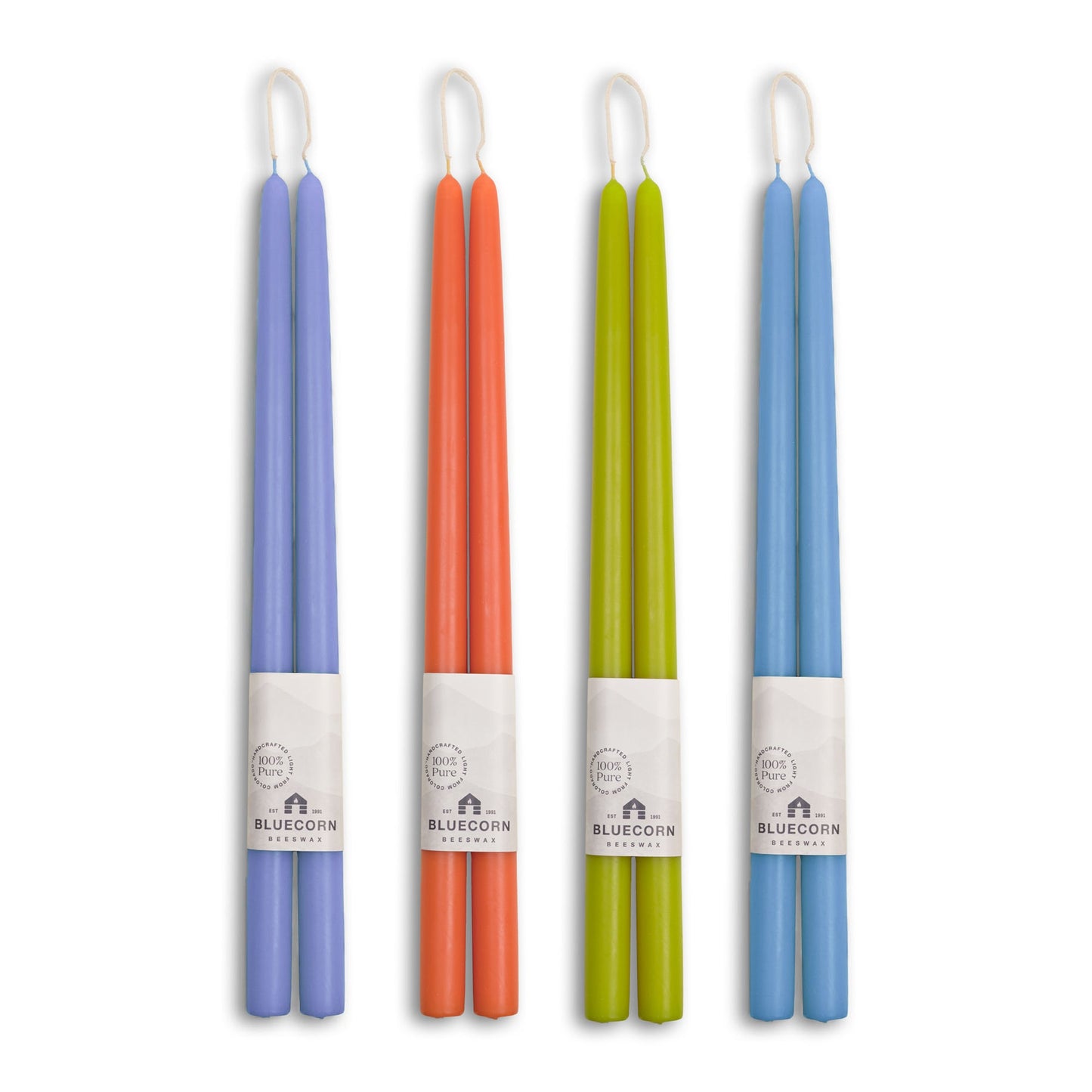 Four colorful candles with labels on a white background