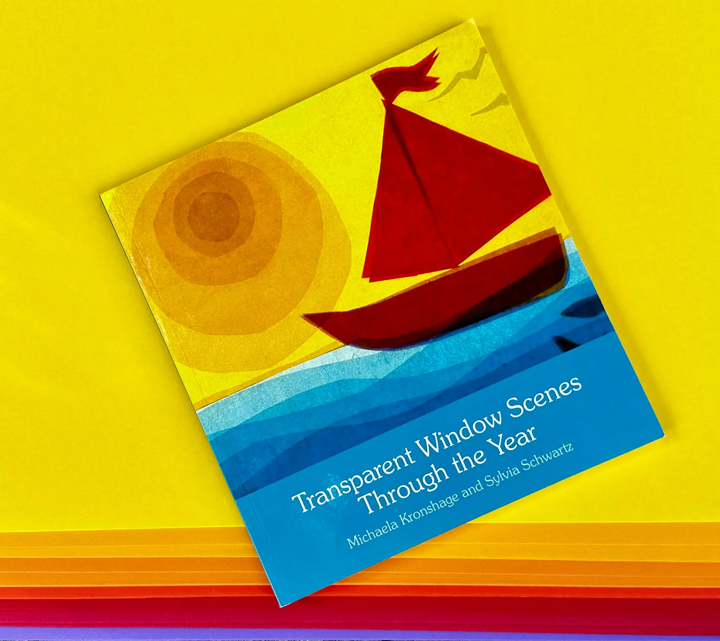 Transparent Window Scenes Through the Year book on top of English Cardboard colors