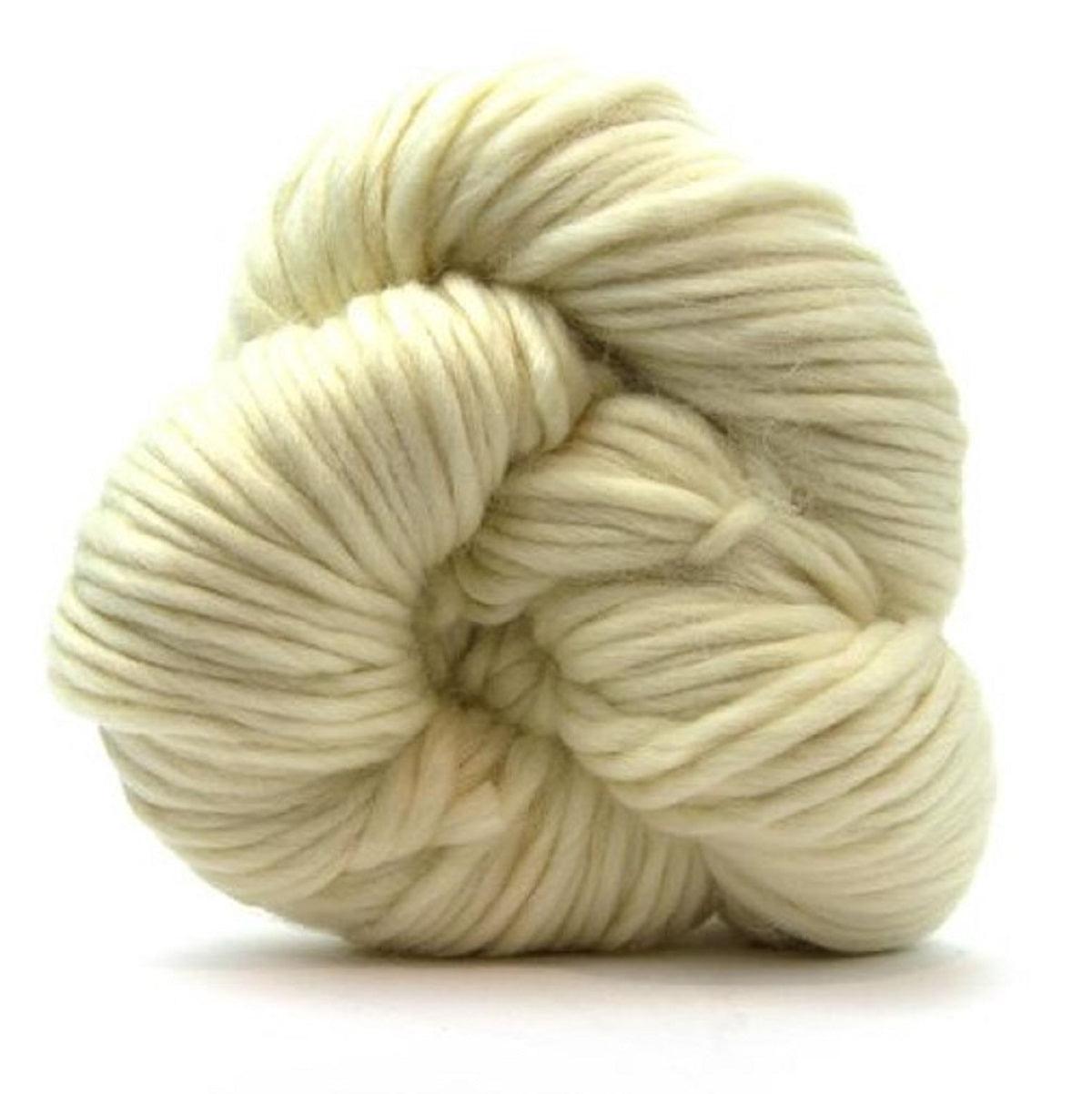 Cream-colored skein of undyed merino super bulky yarn on a white background