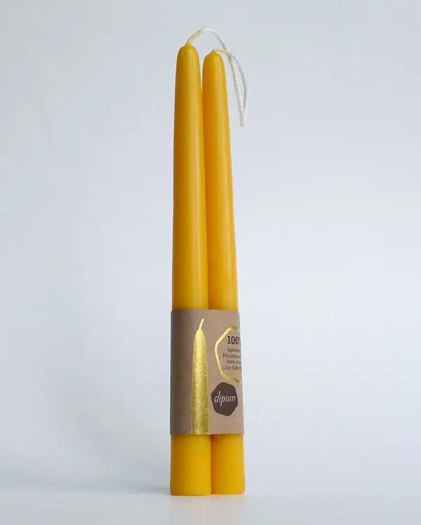 A Pair of Eco Friendly Hand Dipped Beeswax Taper Candleon a gray background