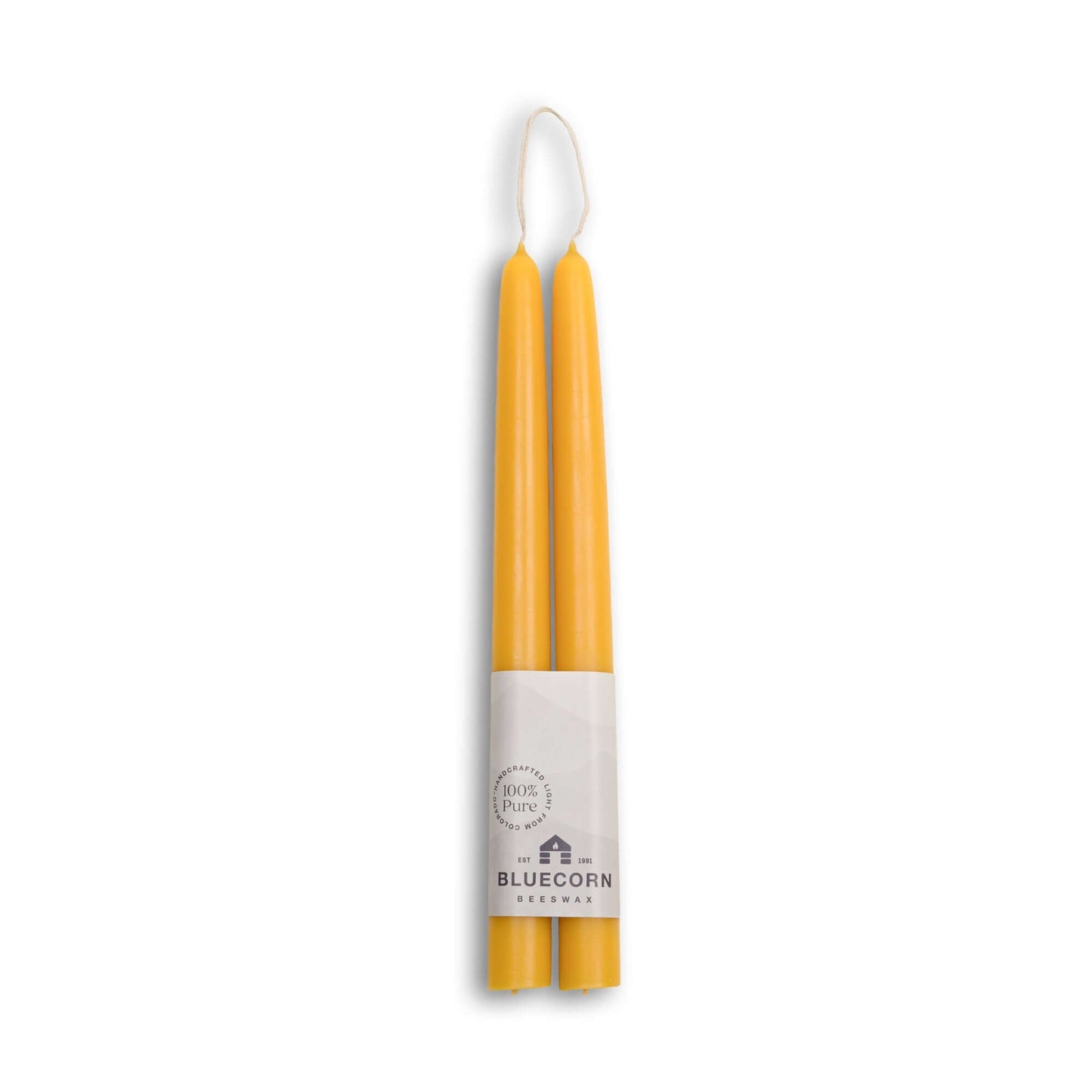 Two yellow candles in packaging with Bluecorn Haus logo on a white background