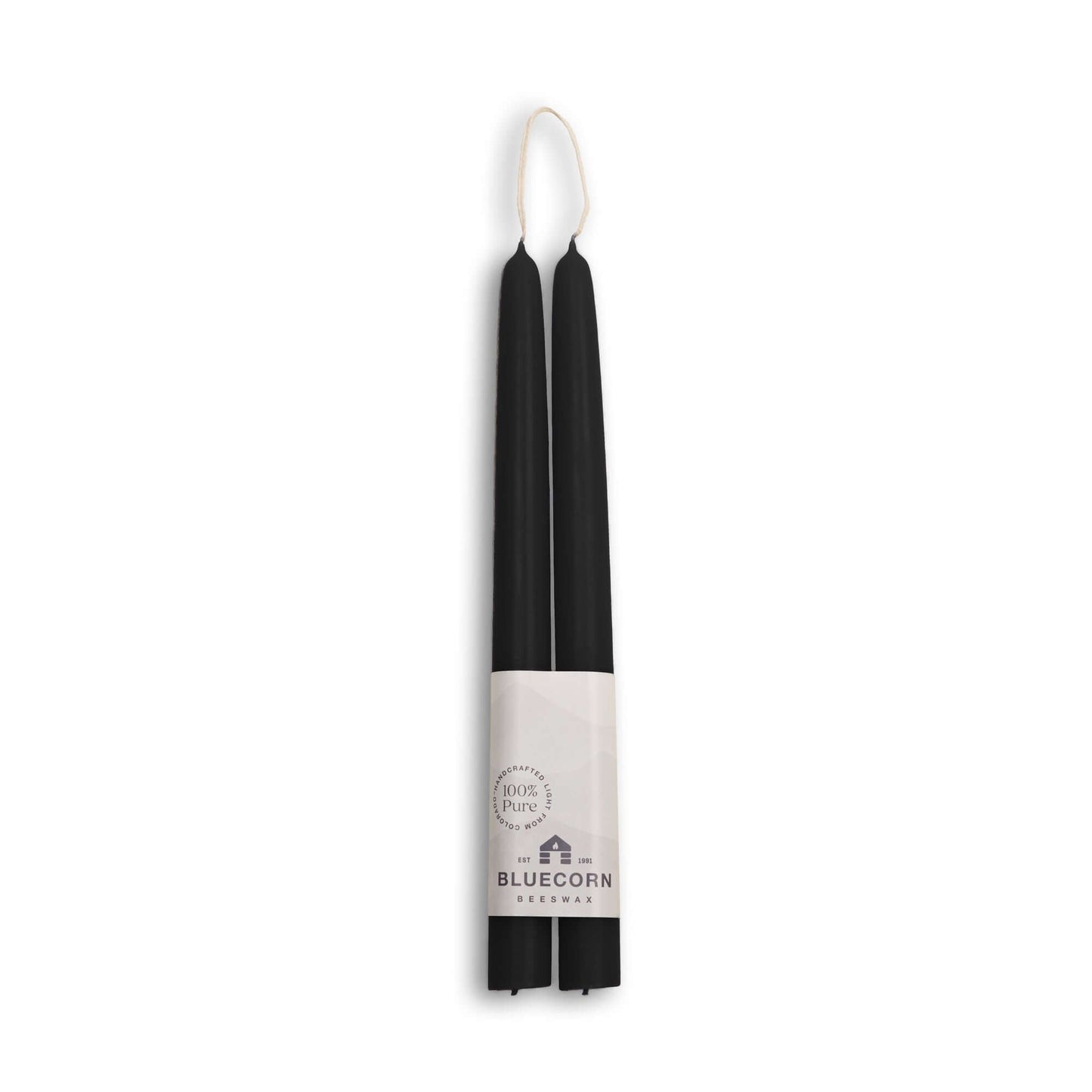 Two black candles in a white holder with 'Bluecorn' branding on a white background