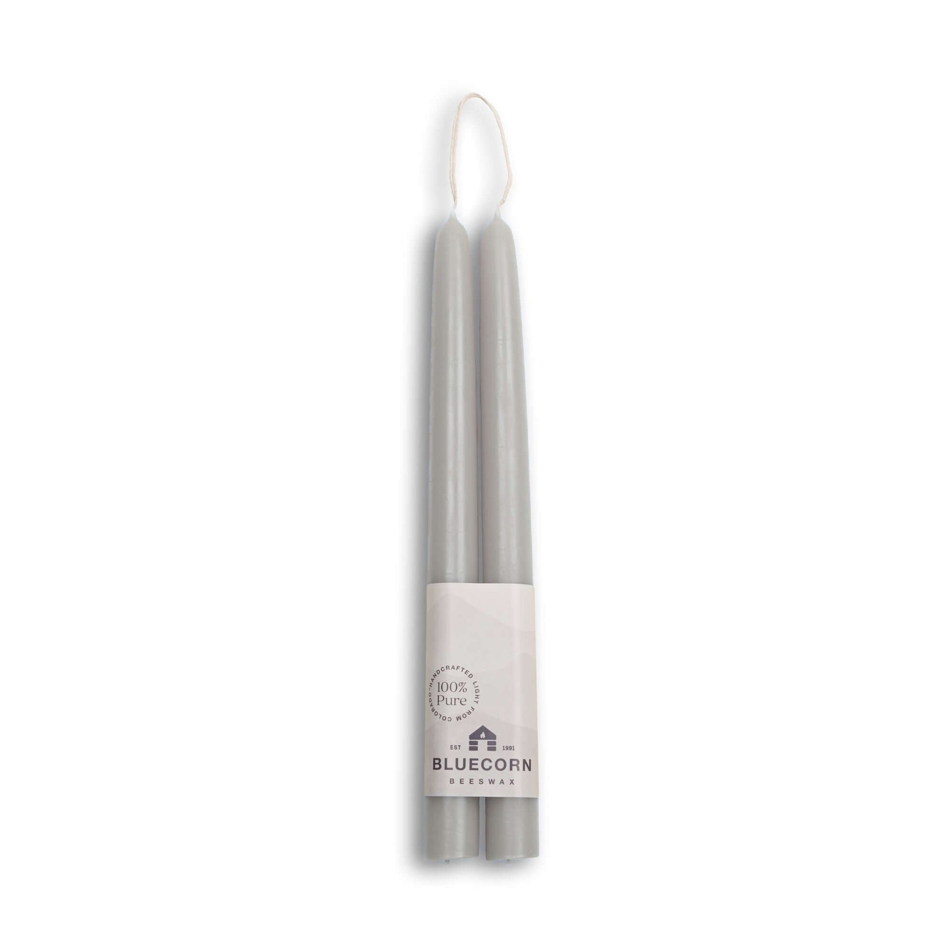 Two silver candles with a Bluecorn Wellness label on a white background