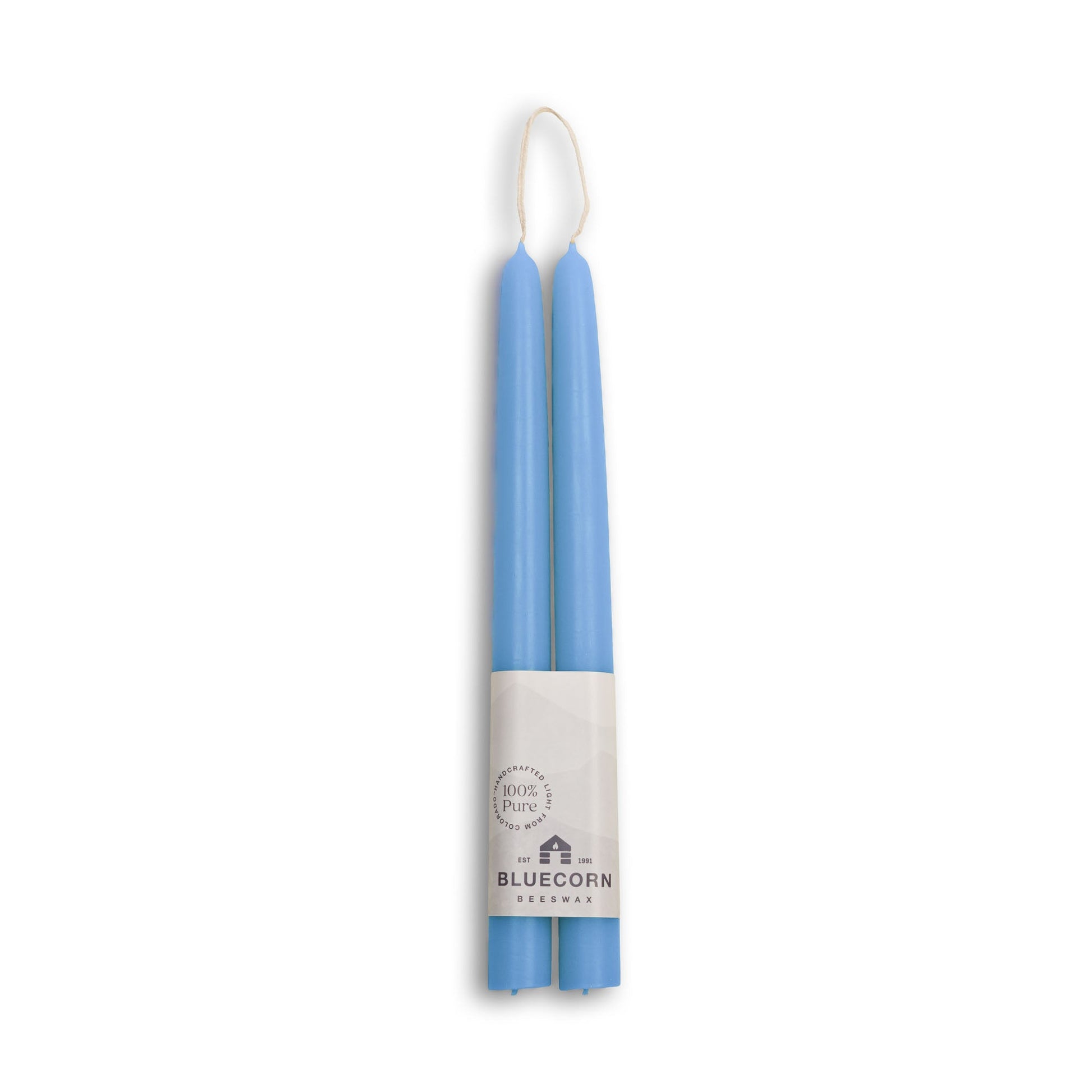 Two blue candles in a white holder with 'Bluecorn' branding on a white background