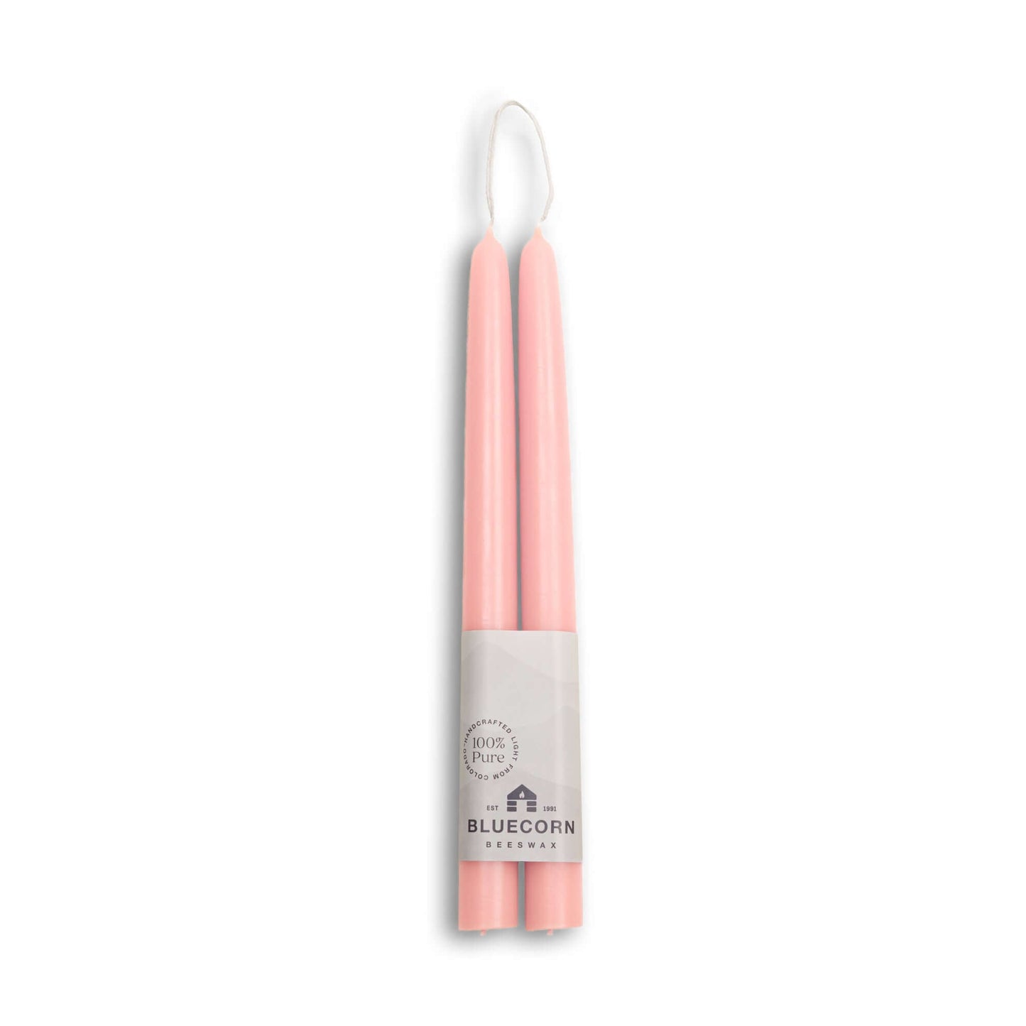 Two pink candles in a white holder with 'Bluecorn' branding on a white background