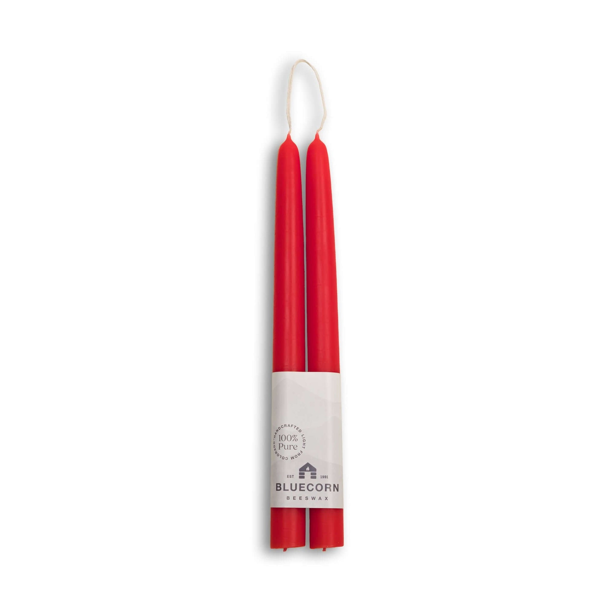 Two red candles in a white holder with Bluecorn Resources branding on a white background