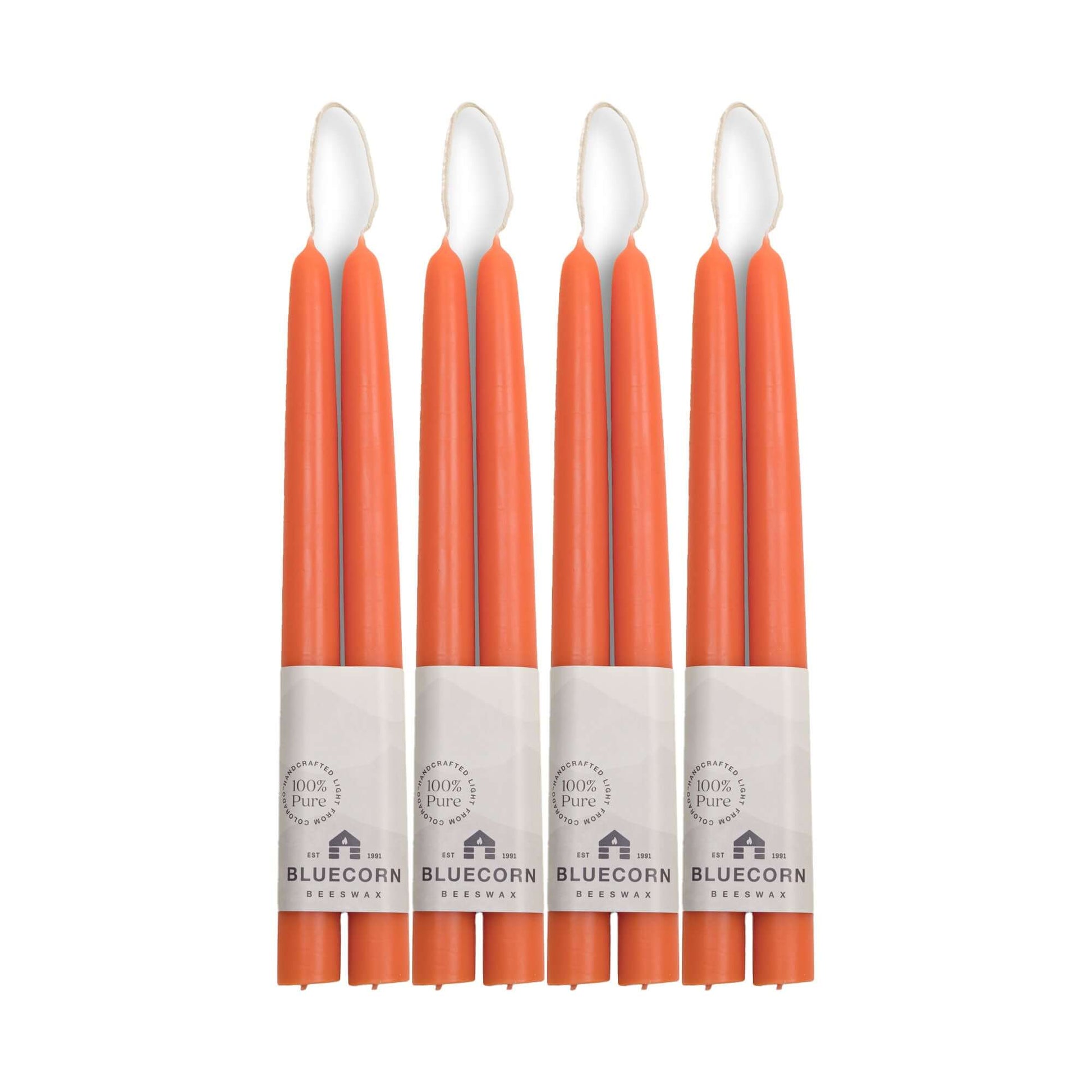 Set of 10-inch apricot beeswax taper candles with Bluecorn branding 