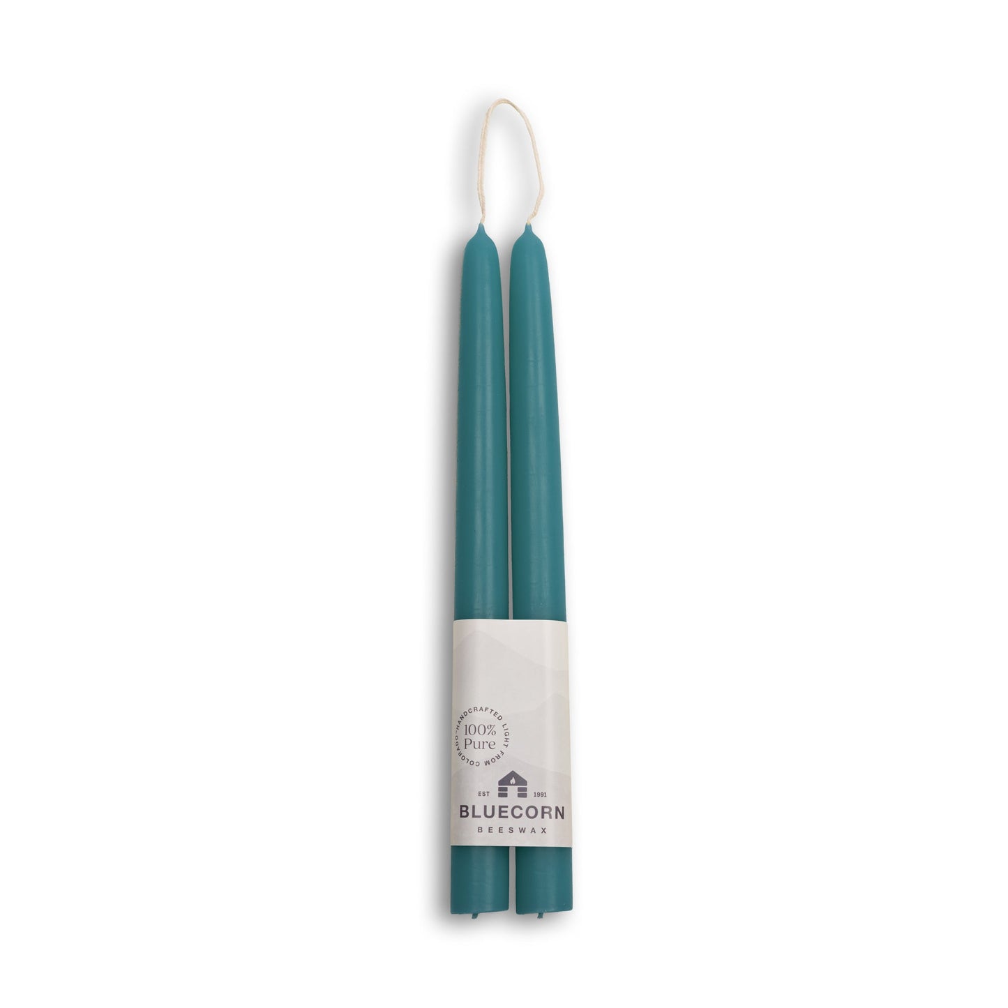 Two teal candles in packaging with 'Bluecorn' branding on a white background