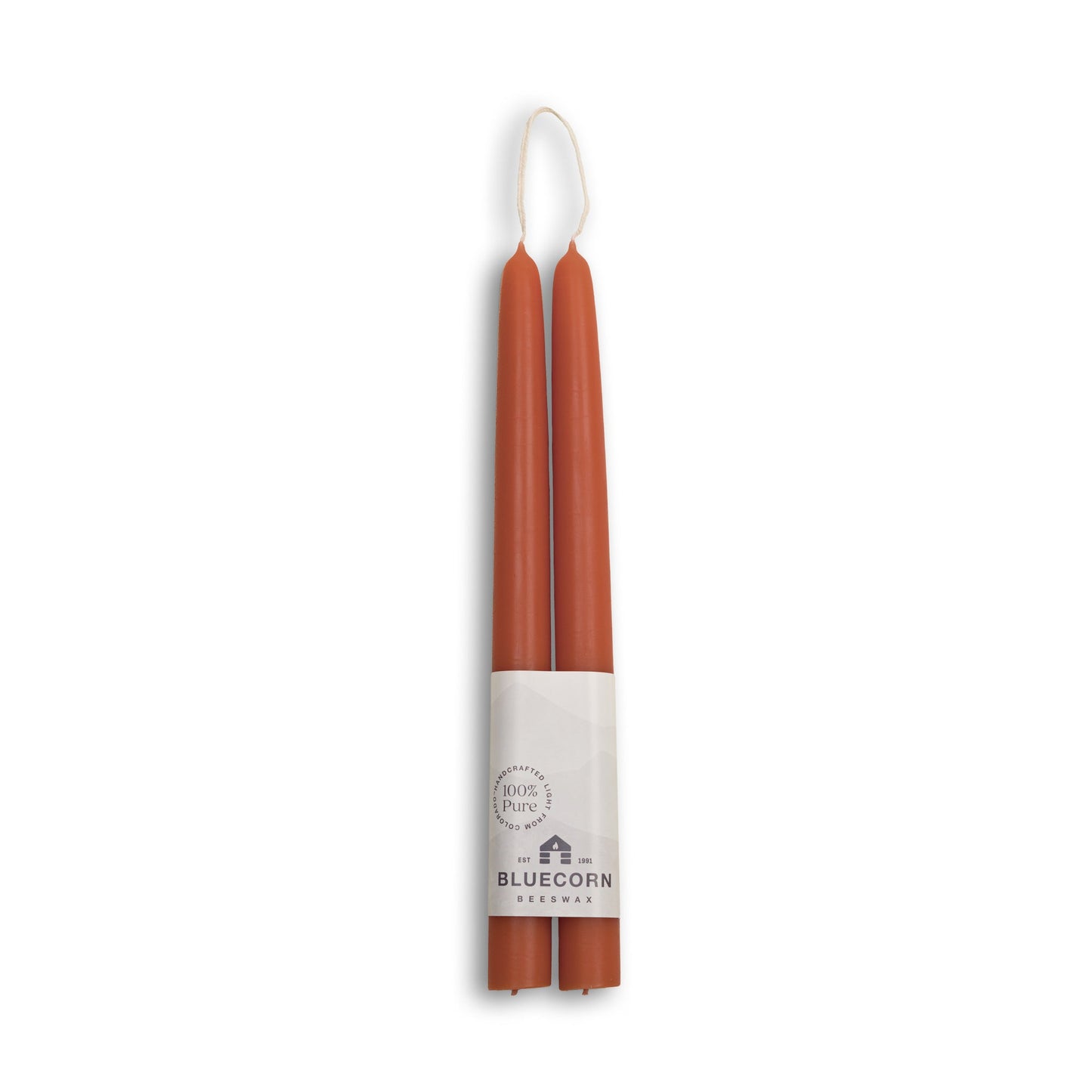 Two terracotta-colored candles in a cardboard holder with 'Bluecorn' branding on a white background.