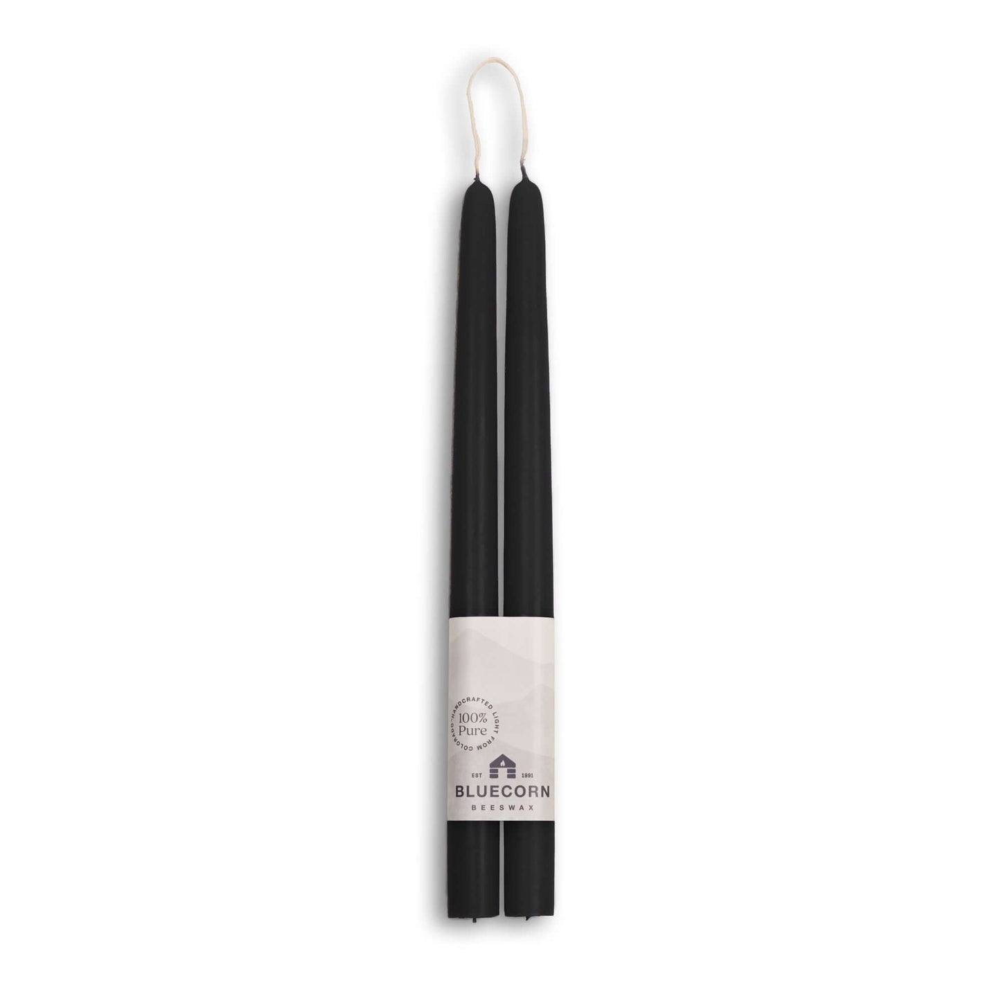 Two black candles with a white label on a white background