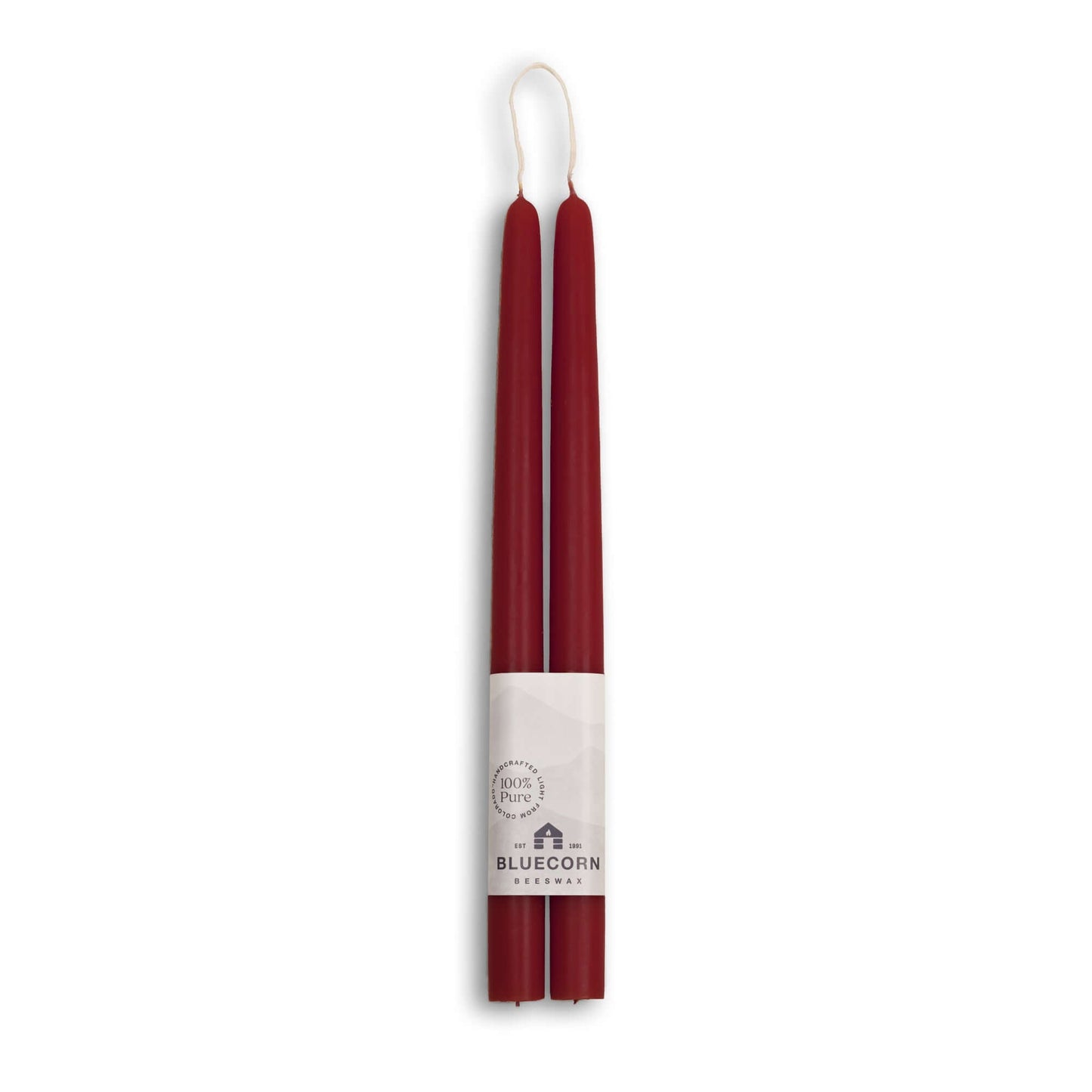 Two burgundy candles with a white label on a white background