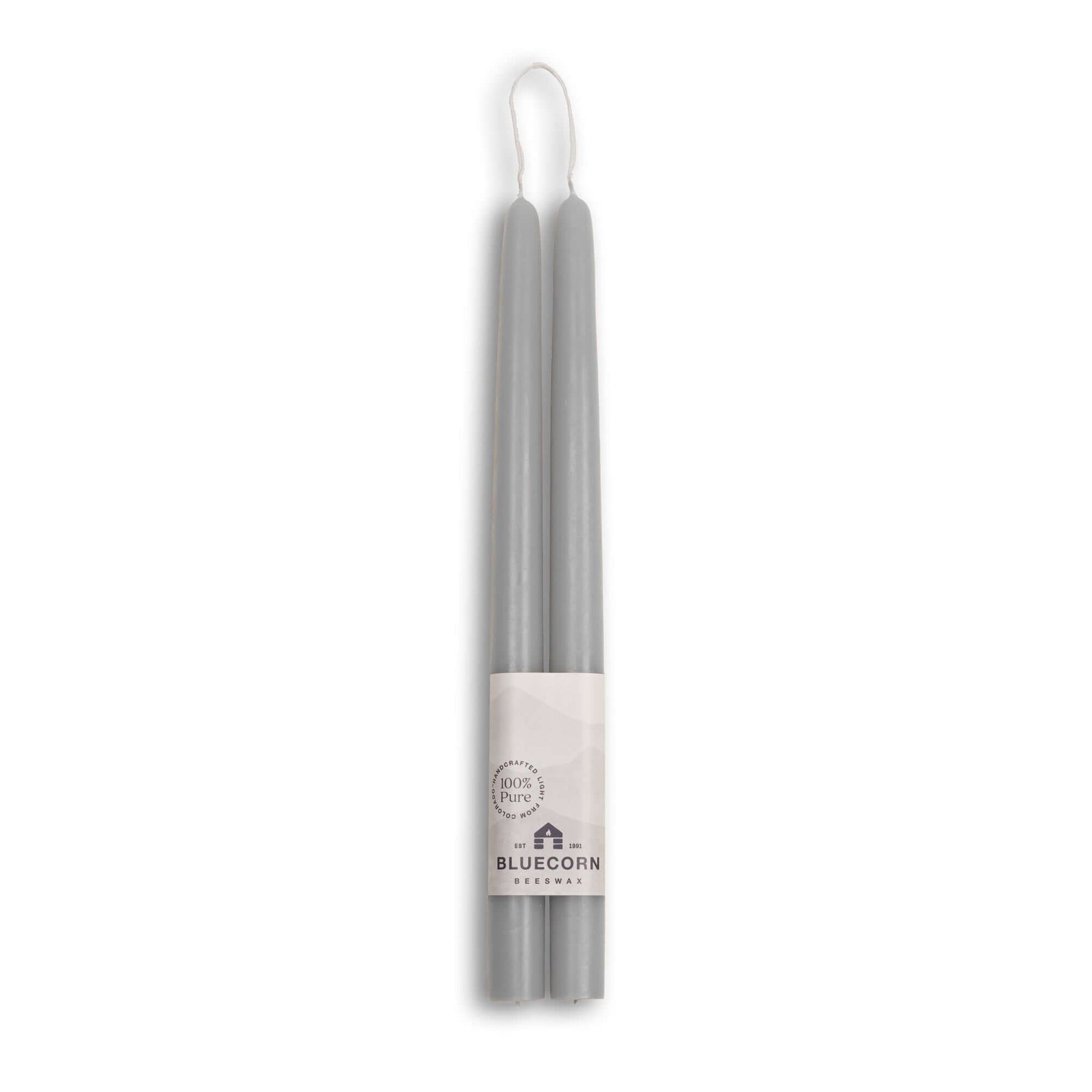 Two gray candles with a white label on a white background