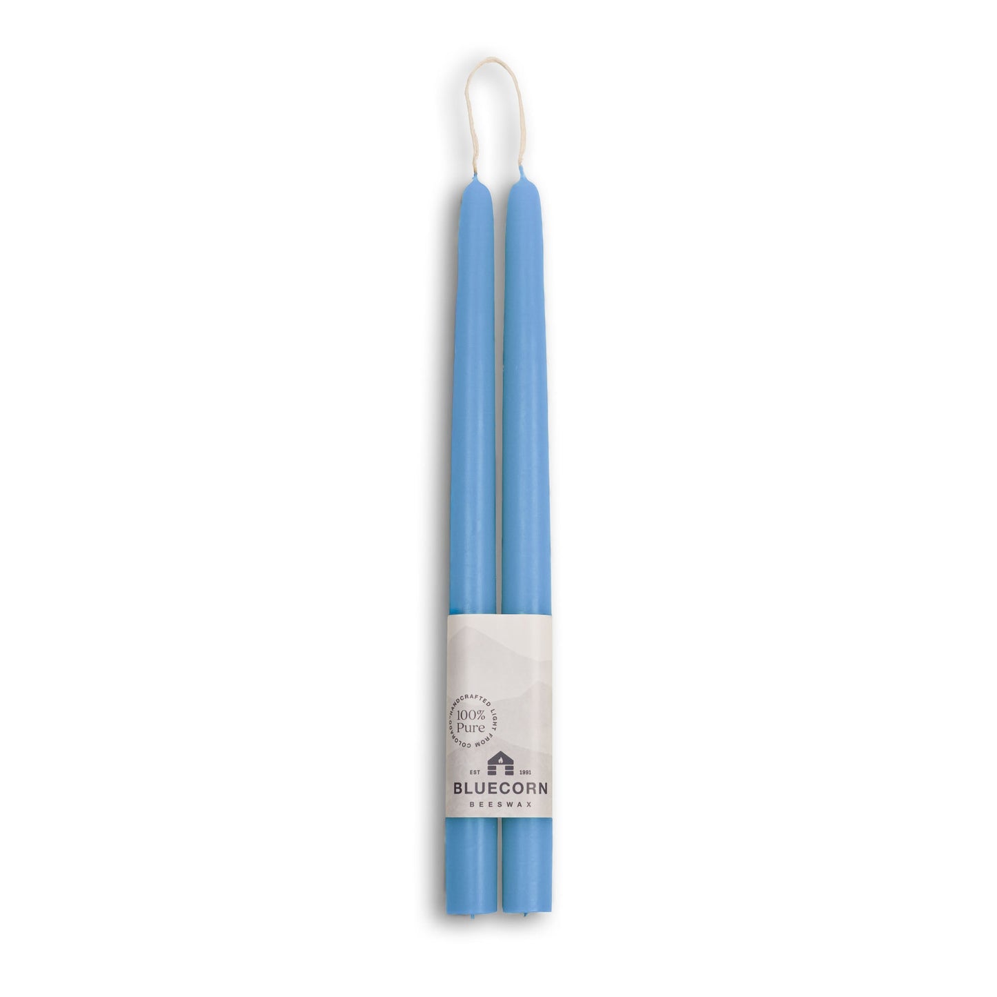Two blue candles in packaging with a brand label on a white background