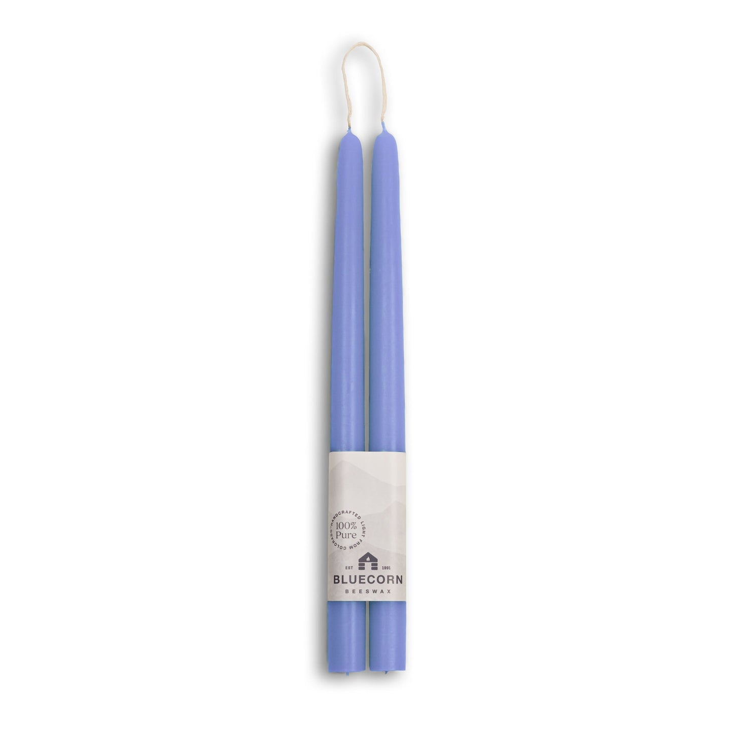 Two purple candles in packaging with a brand label on a white background