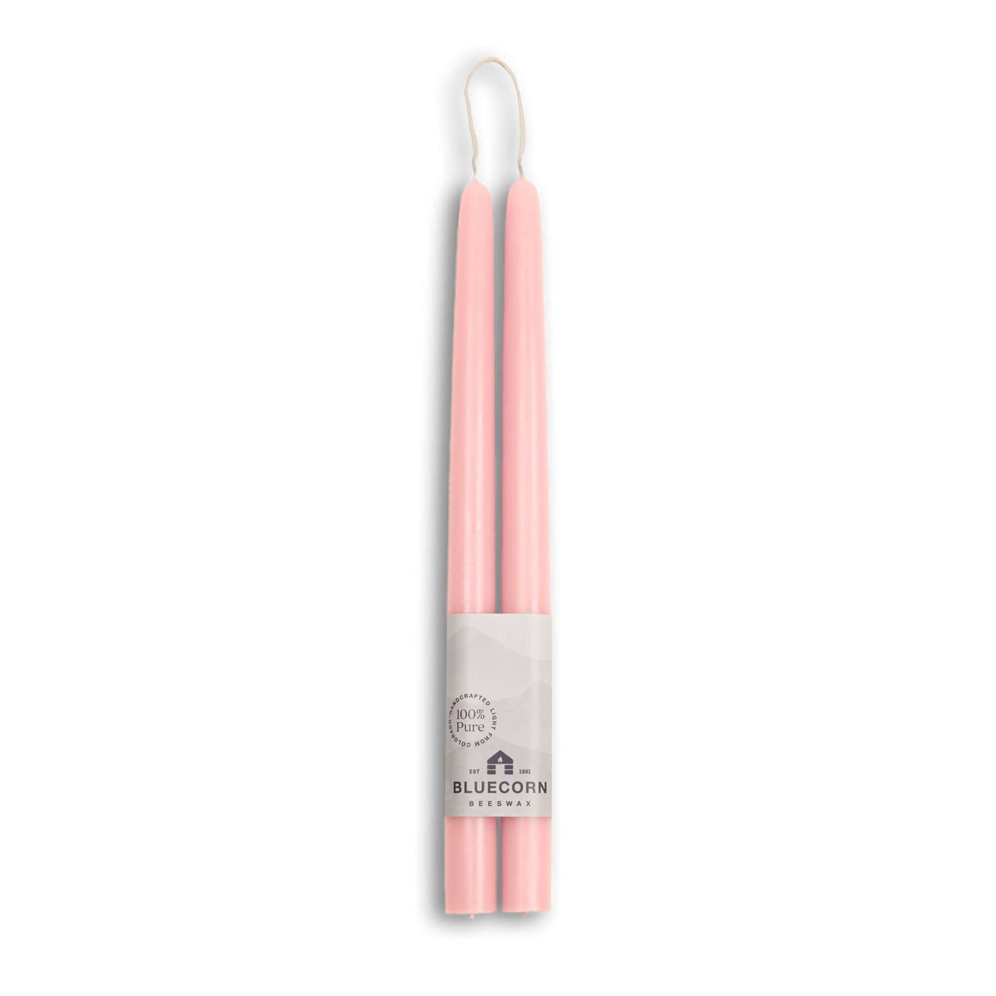 Two pink candles in a white holder with 'Bluecorn' branding on a white background