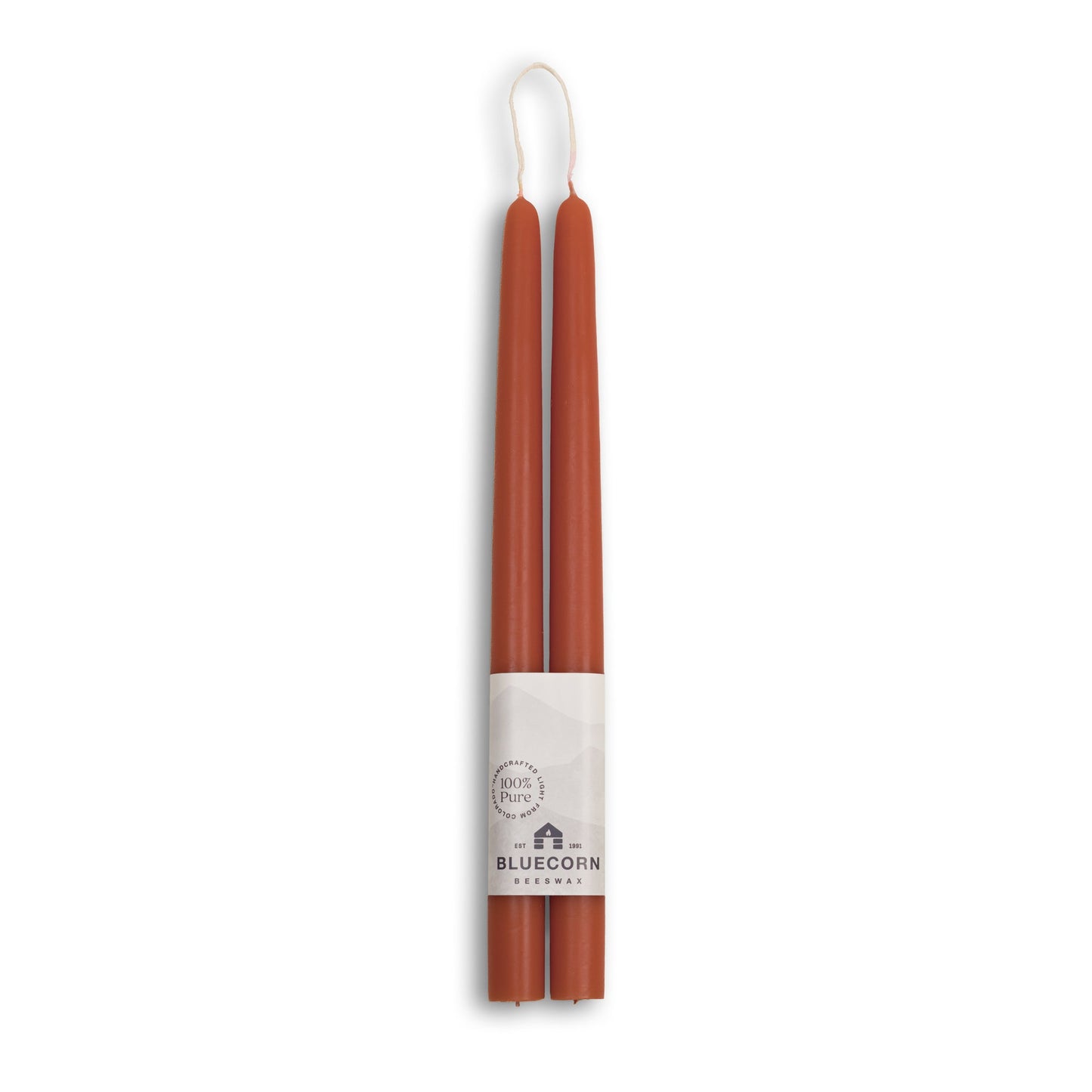 Two brown candles with a white label on a white background