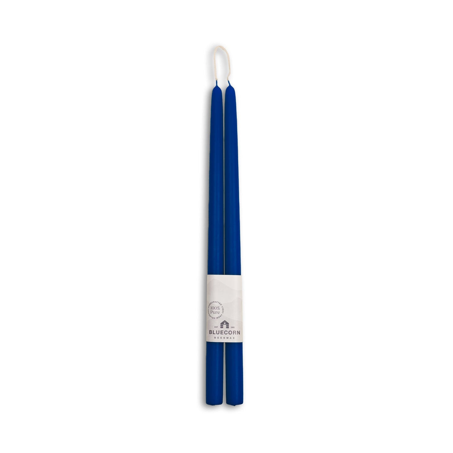 Two blue candles with a white label on a white background