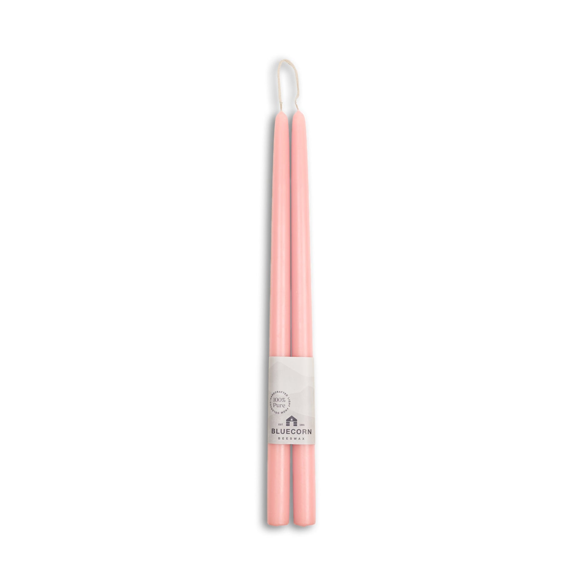 Pink and white candles with a visible brand label on a white background