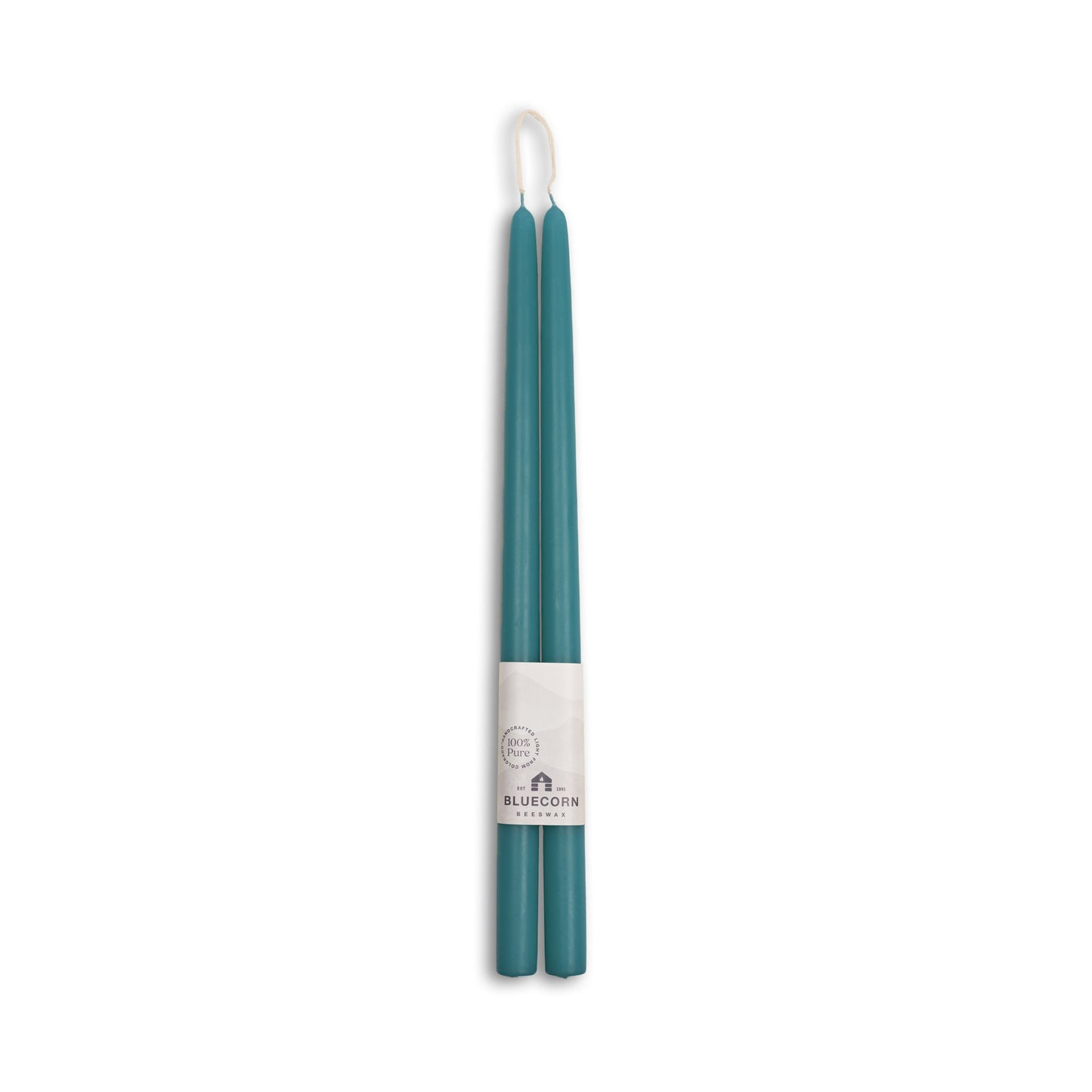 Two teal candles in a white holder with 'Bluecorn' branding on a white background