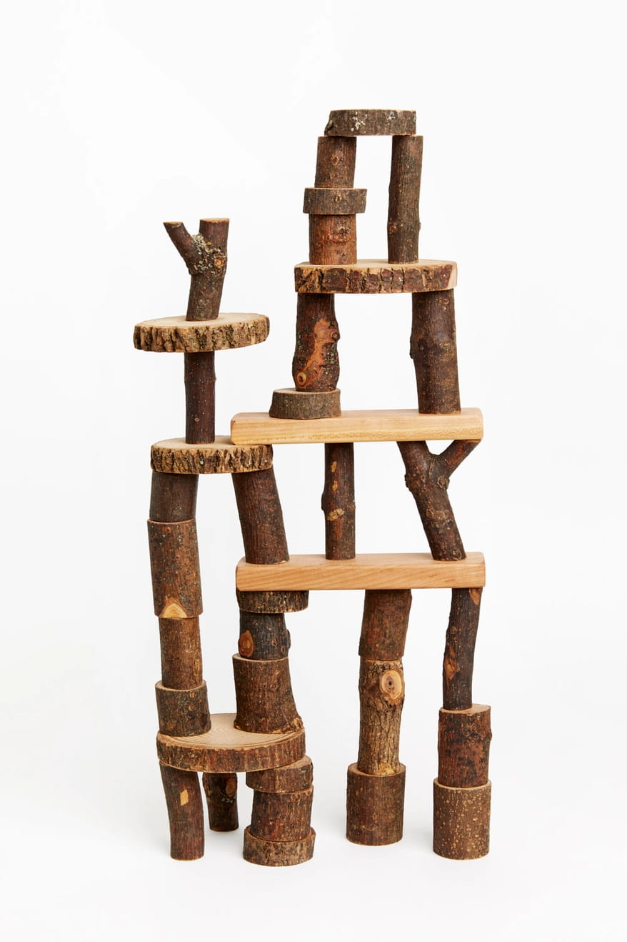 Barked Tree Blocks for open ended play stacked against a white background