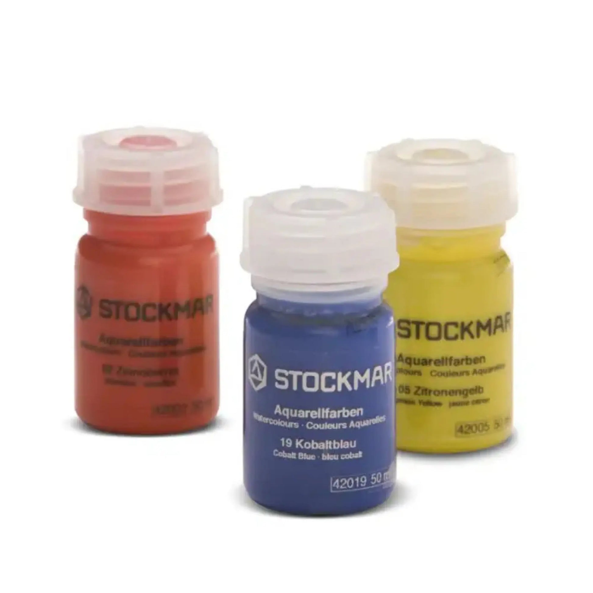 Three bottles of Stockmar watercolor paint in red, blue, and yellow on a white background.