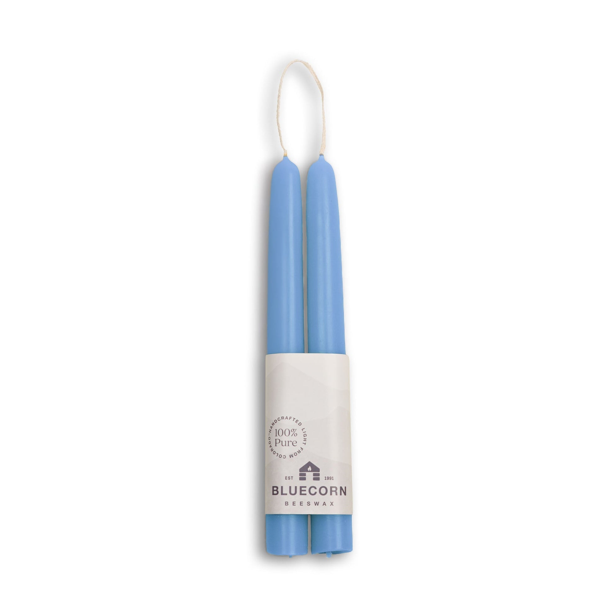 Two blue candles in a white cylindrical holder with 'Bluecorn' branding on a white background.