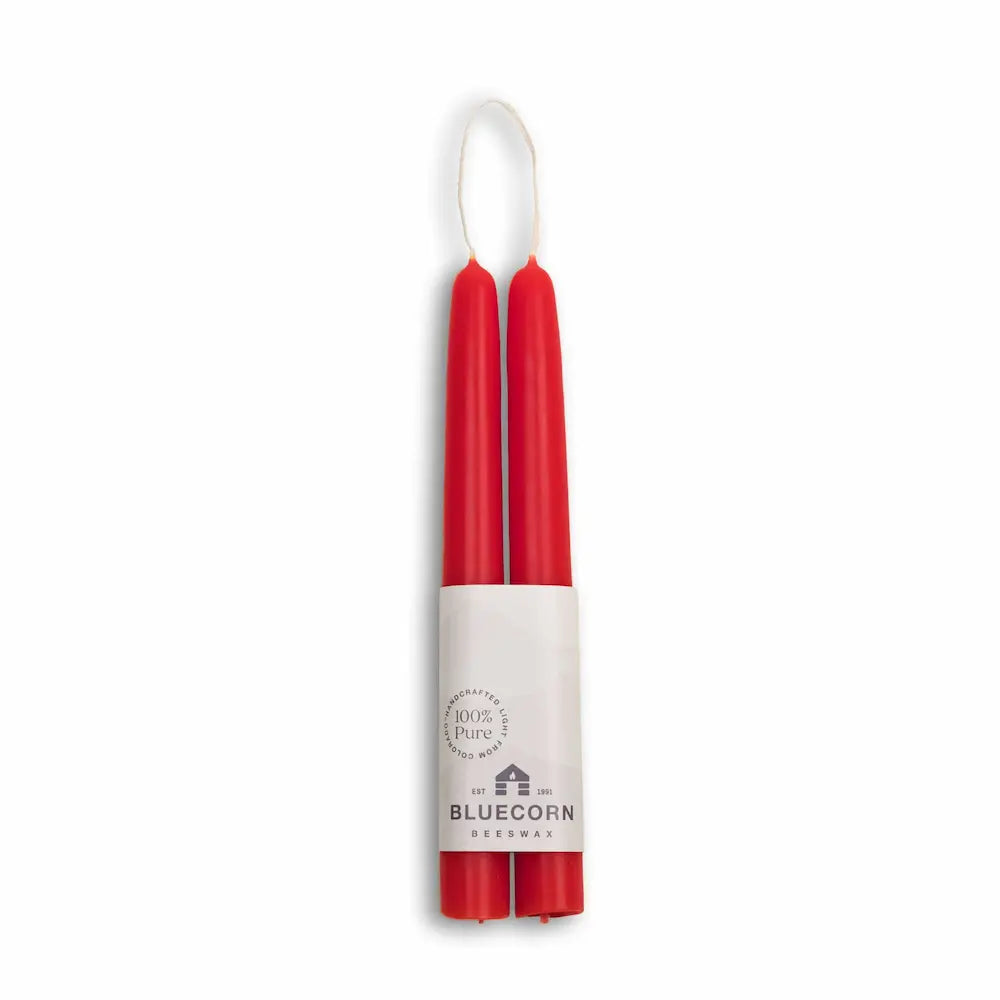 Red candles in a white holder with 'Bluecorn' branding on a white background