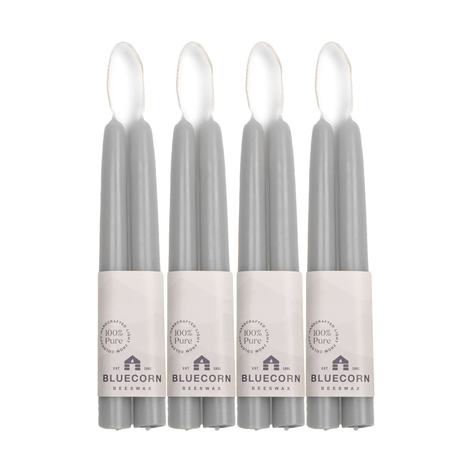 Four gray 8-inch beeswax taper candles in packaging with 'Bluecorn' 