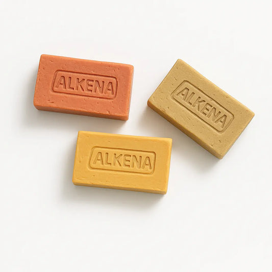 Three Alkena beeswax clay bars on a white background