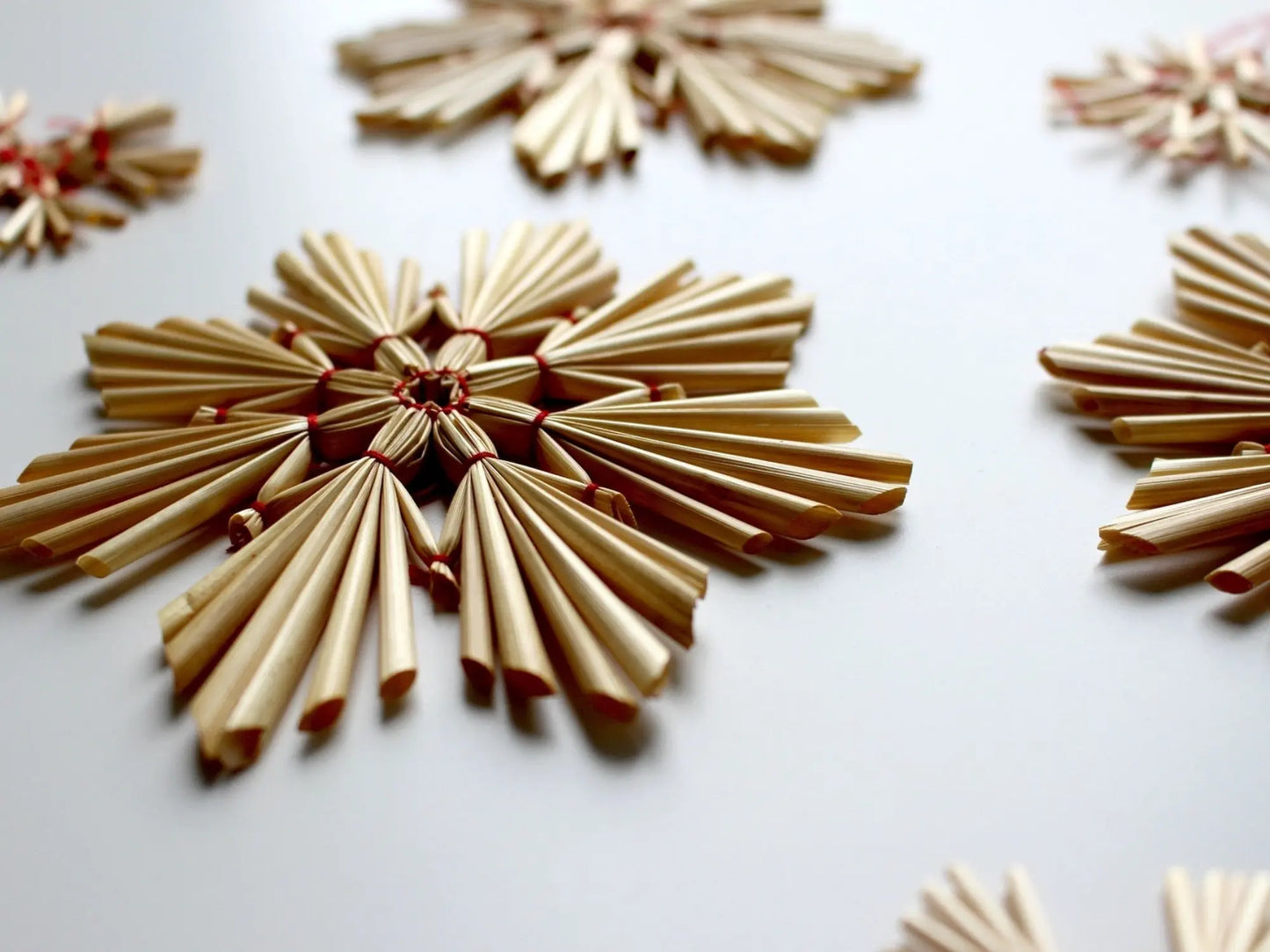 Swedish Straw Ornaments lying flat on a light background