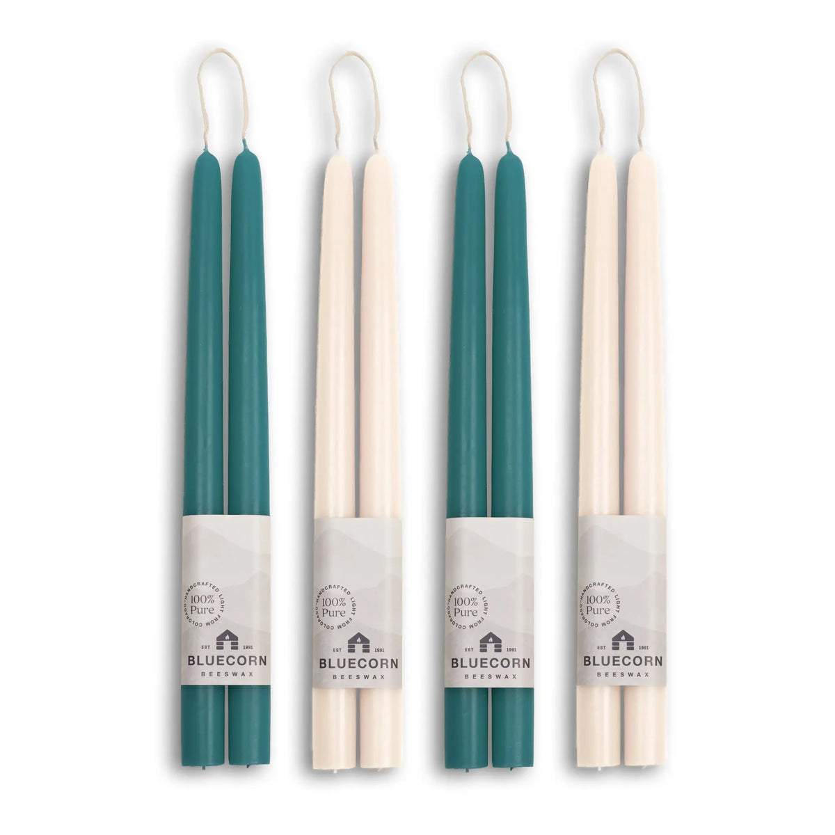 Four teal and beige candles with visible branding on a white background
