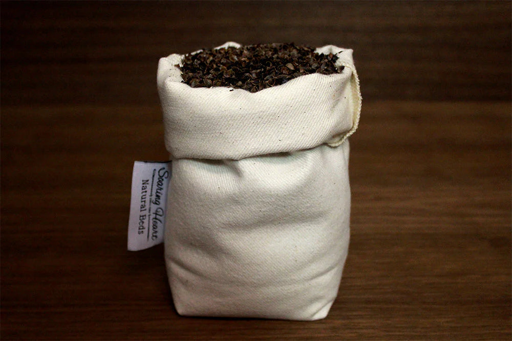 Small bag of buckwheat natural filling with a visible label on a wooden surface