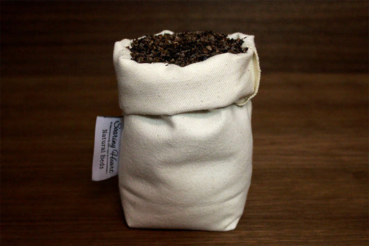 Small bag of buckwheat natural filling with a visible label on a wooden surface
