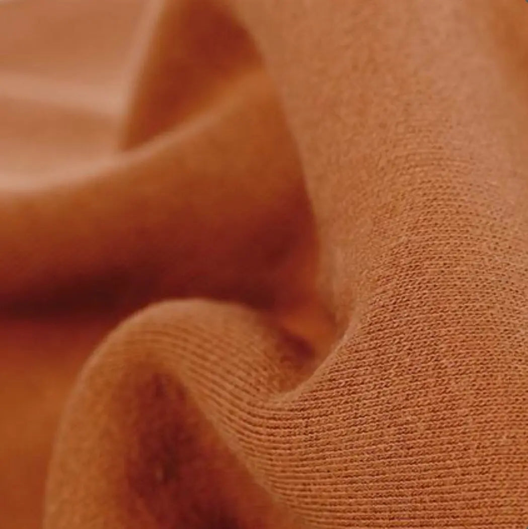 Close-up of textured brown organic cotton tricot dollmaking fabric